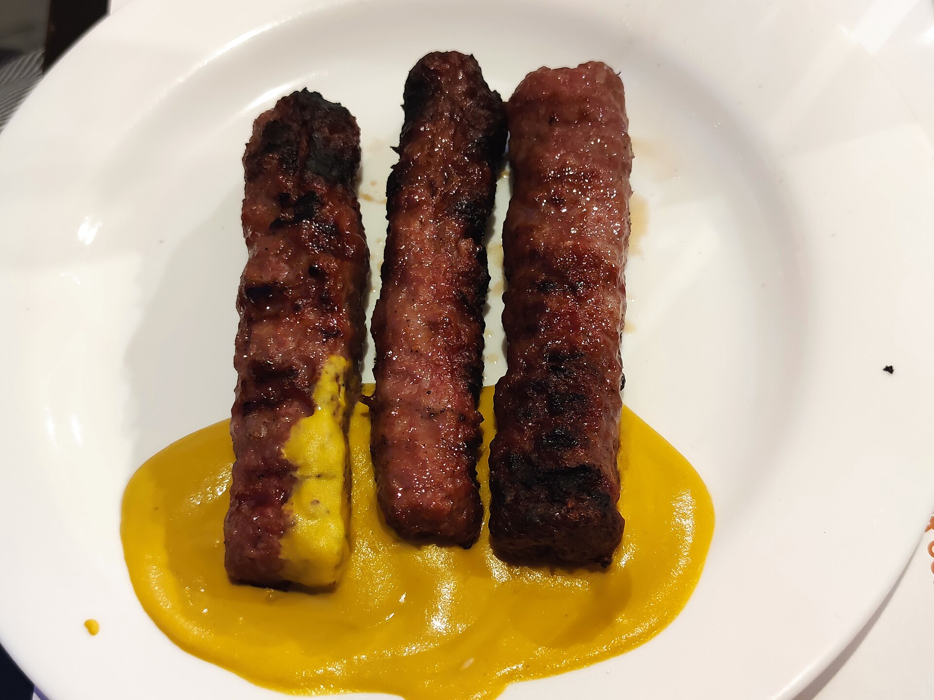 Mici (grilled minced-meat rolls) with mustard